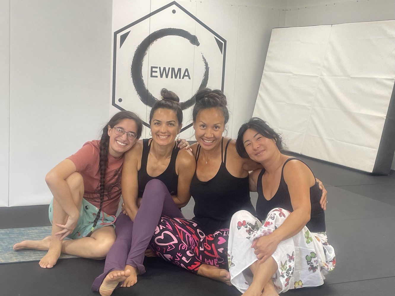Lisa and students smiling together at Evolution Wellness Martial Arts studio in Palmas del Mar