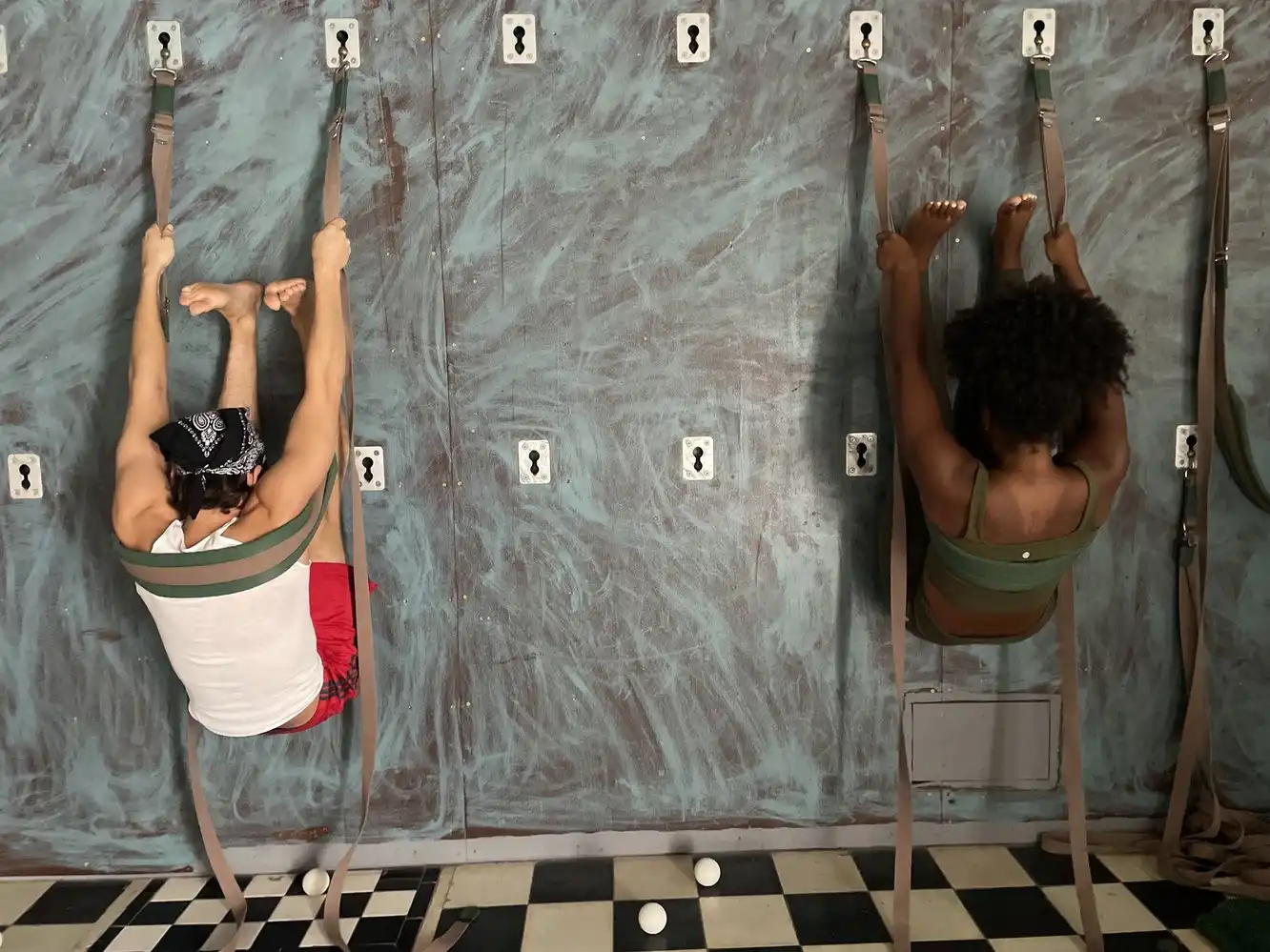 Two students practicing Iyengar wall yoga at El Segundo Nivel in downtown Humacao